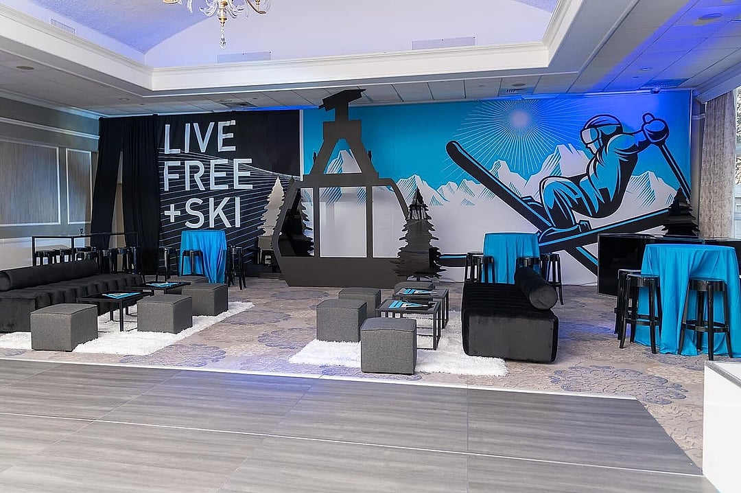 Lounge seating in front of a large mountain and skier mural