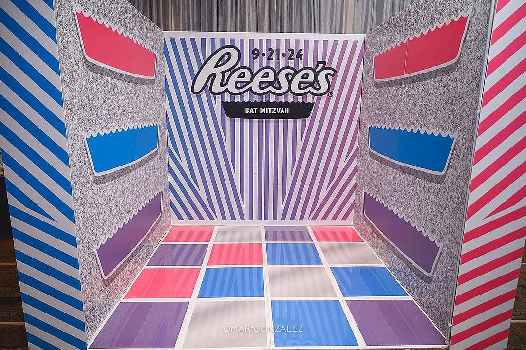 Striped photo booth with a colorful tiled floor