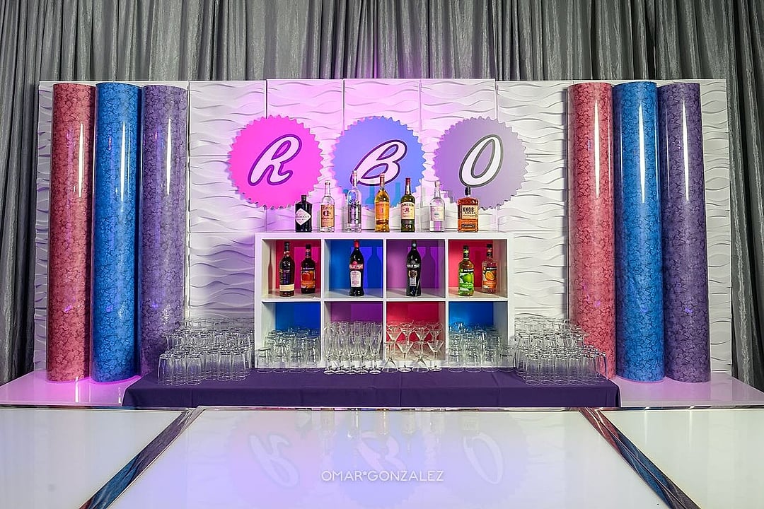Monogrammed bar framed by tall glittering columns