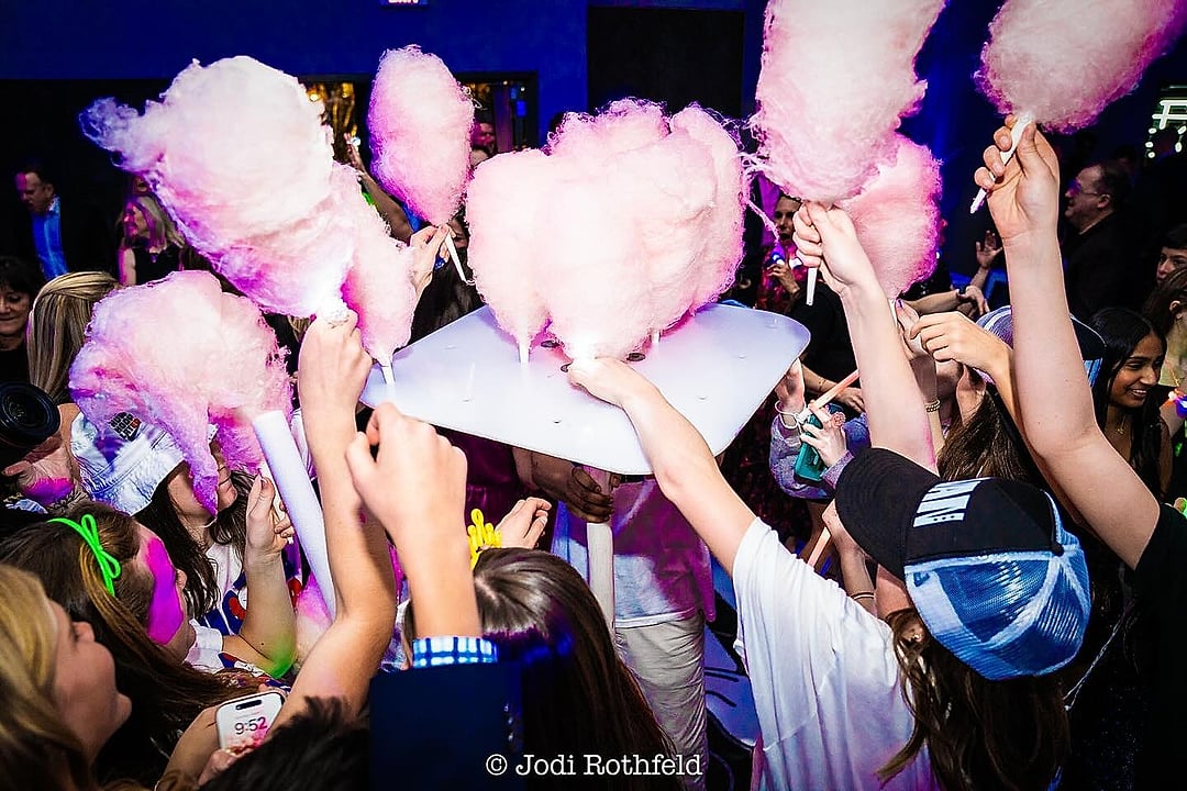 Guests celebrating with oversized pink cotton candy
