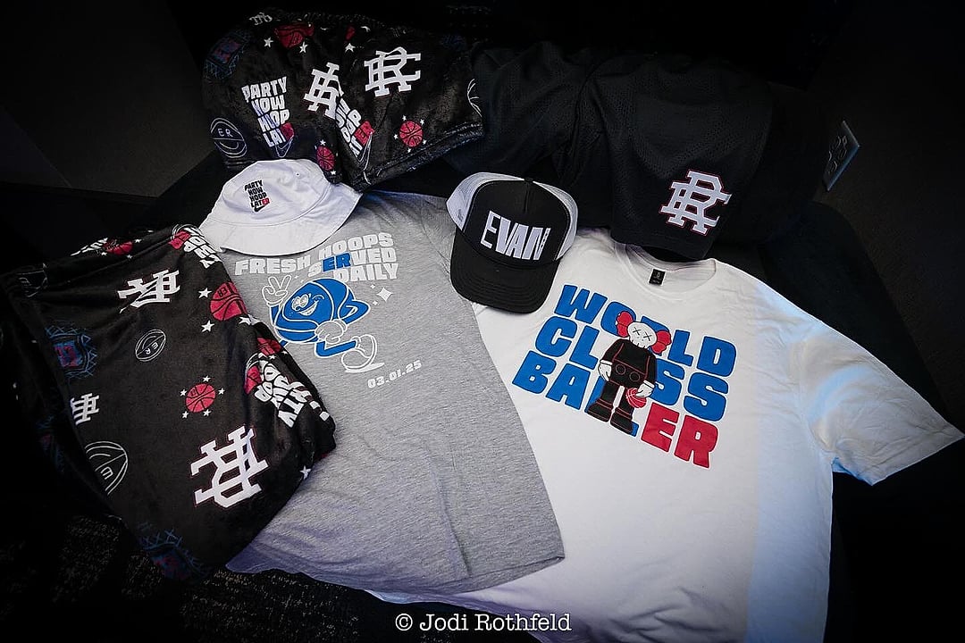 Custom hats and t-shirts laid out as party favors