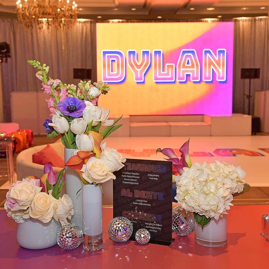 Floral centerpiece before a large name screen