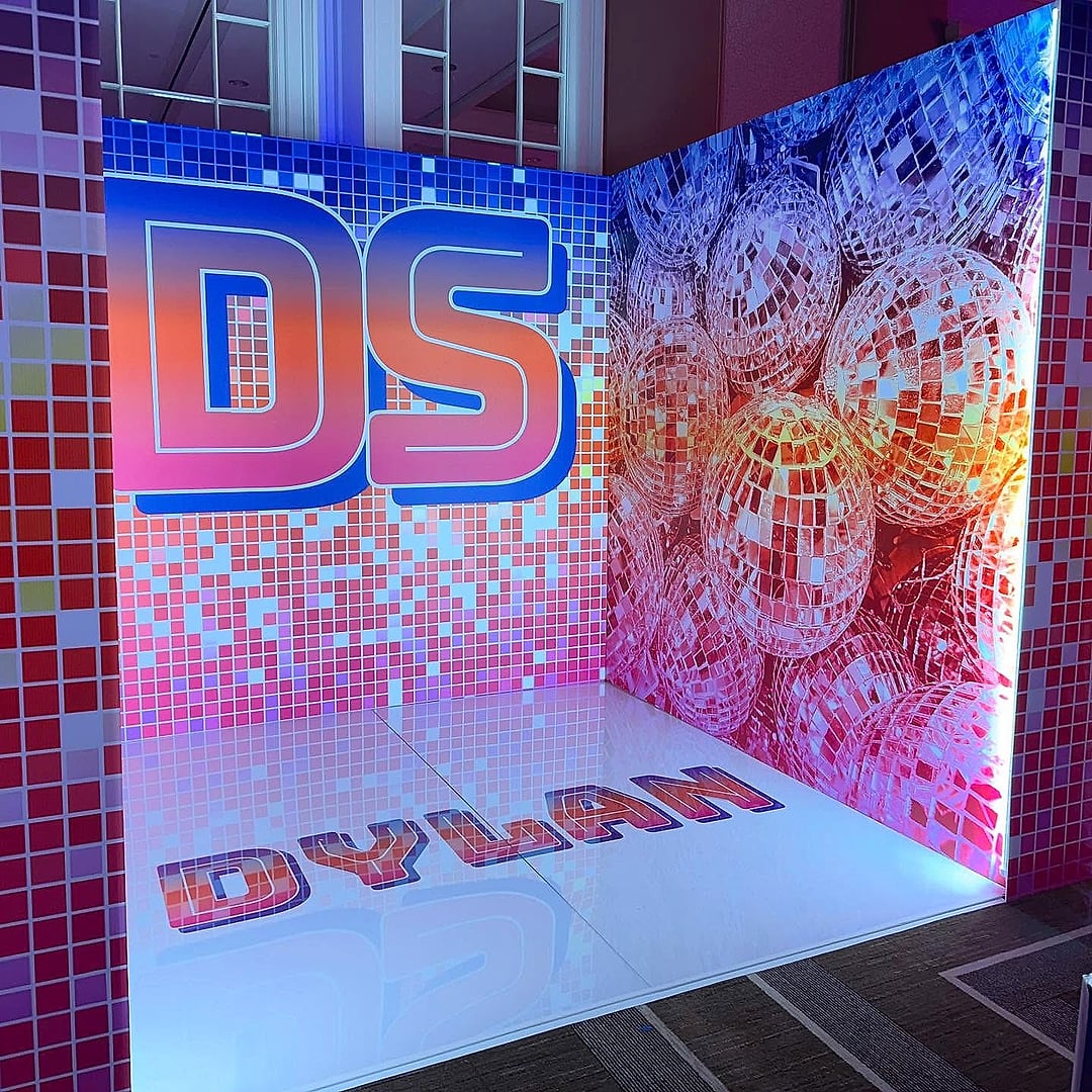 Sequin photo booth with a monogram and glossy floor