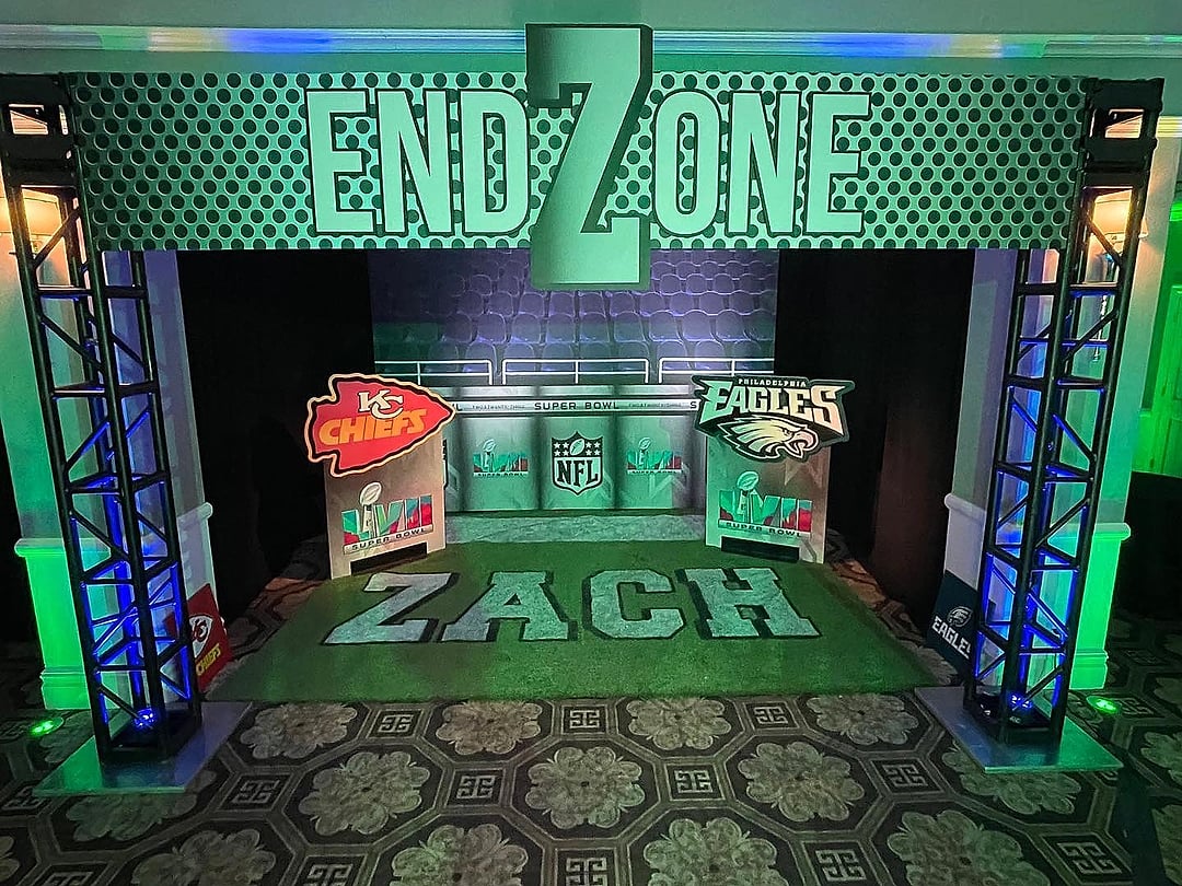 Football end-zone entrance with lit truss towers