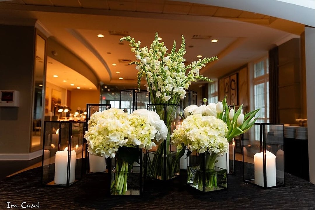White hydrangea and tulip arrangement with tall candles