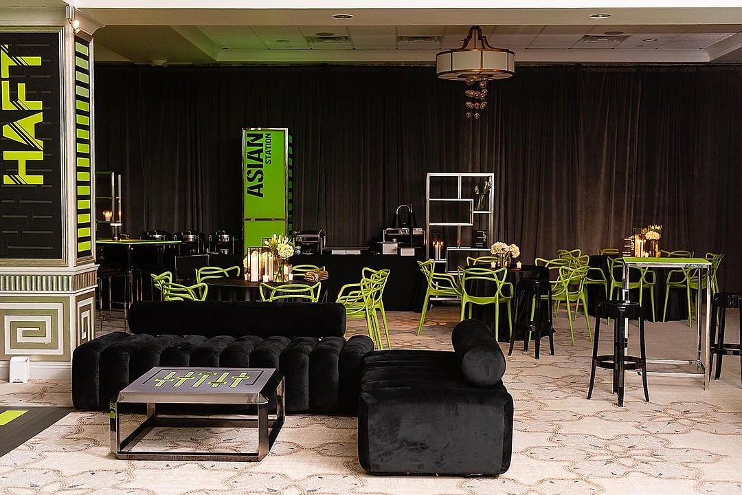 Black velvet lounge furniture and green chairs beside food stations